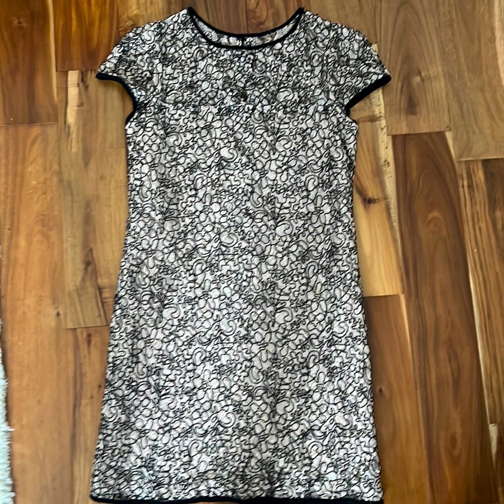 Designer cocktail dress in soft pink and black with artistic lace